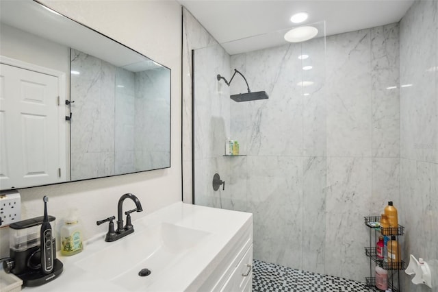 bathroom featuring vanity and a marble finish shower