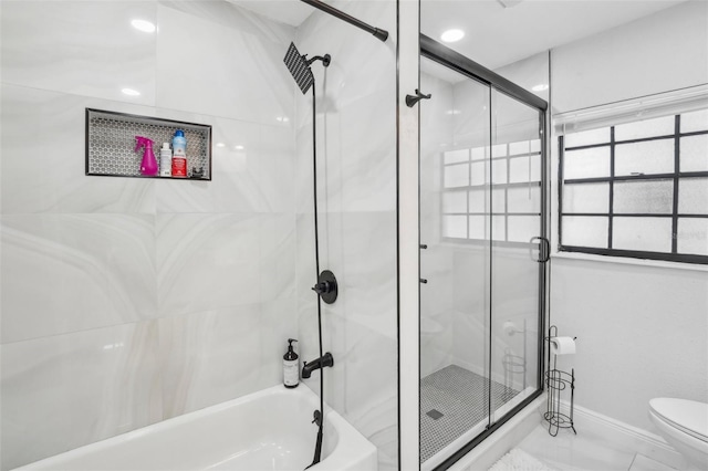 full bath featuring baseboards, toilet, and combined bath / shower with glass door