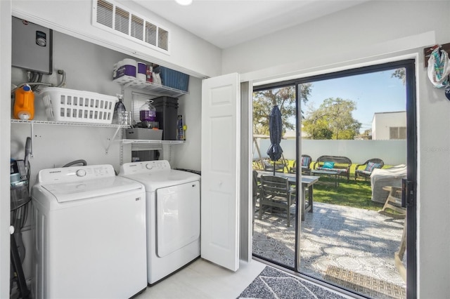 washroom featuring laundry area, visible vents, and washer and dryer