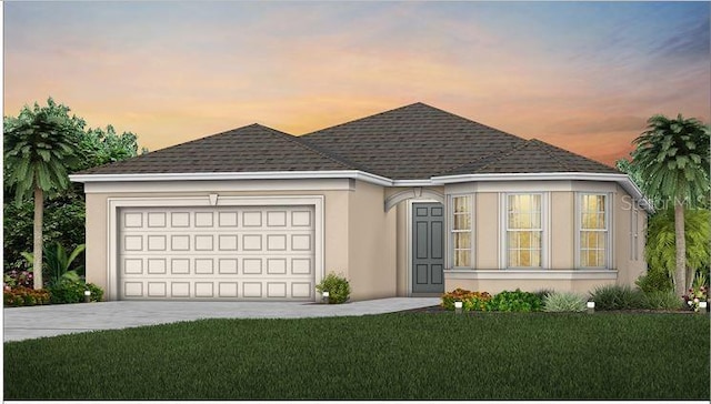 view of front facade with a garage, a shingled roof, driveway, stucco siding, and a front yard