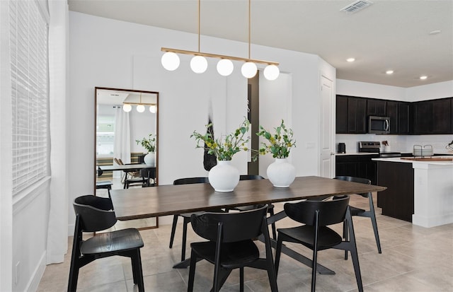 dining area with light tile patterned floors, visible vents, and recessed lighting