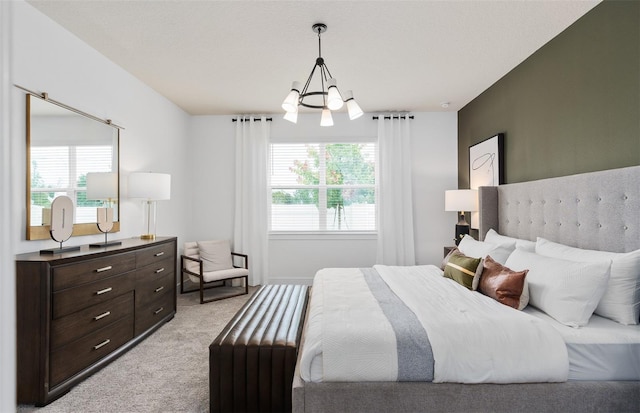 bedroom with light carpet, multiple windows, and a chandelier