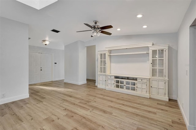 2502 SW 23rd Cranbrook Dr, Boynton Beach, FL 33436 - unfurnished living room with light wood-style flooring, baseboards, a ceiling fan, and a skylight