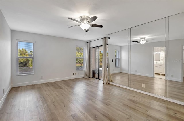 2502 SW 23rd Cranbrook Dr, Boynton Beach, FL 33436 - unfurnished bedroom with ensuite bathroom, light wood finished floors, baseboards, and a ceiling fan
