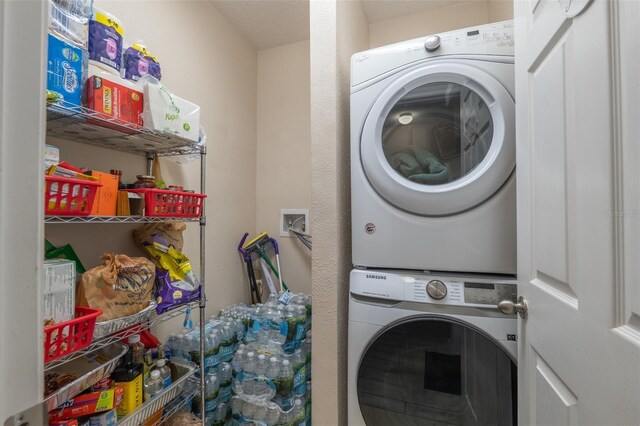 washroom with stacked washer and dryer