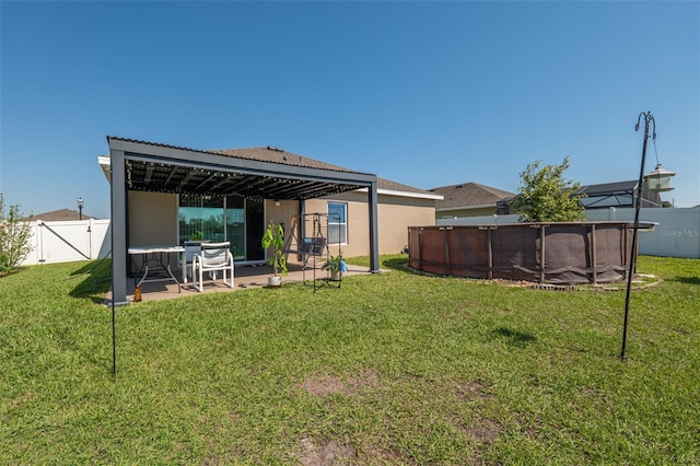 back of property featuring a yard, a patio, stucco siding, a fenced backyard, and an outdoor pool