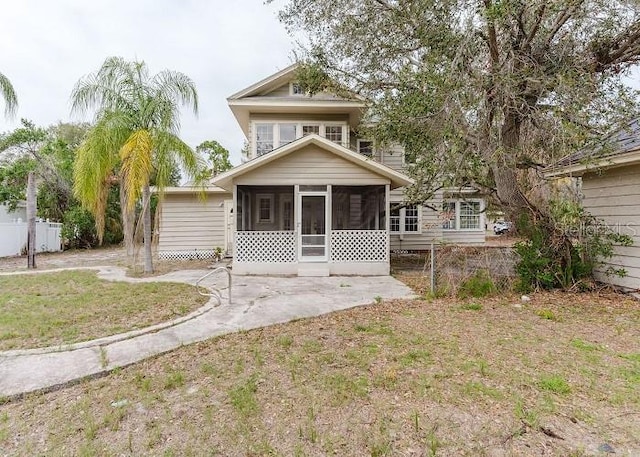 back of house featuring a sunroom and fence