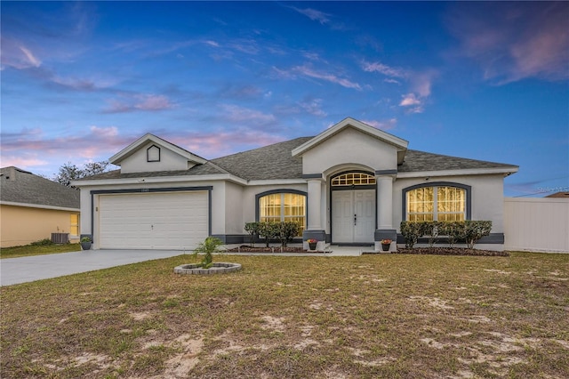 single story home with a yard, stucco siding, concrete driveway, central AC, and a garage