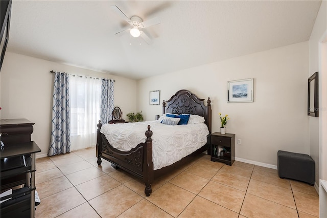 bedroom featuring ceiling fan, light tile patterned flooring, and baseboards