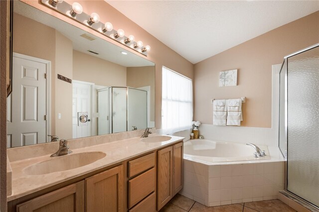 bathroom with a stall shower, a sink, lofted ceiling, and a bath