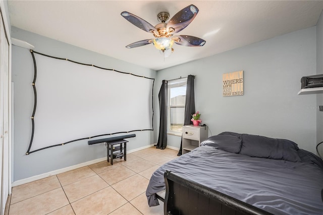 bedroom featuring light tile patterned floors, ceiling fan, and baseboards