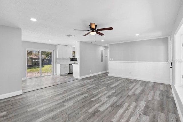 unfurnished living room featuring a ceiling fan, light wood-type flooring, baseboards, and recessed lighting