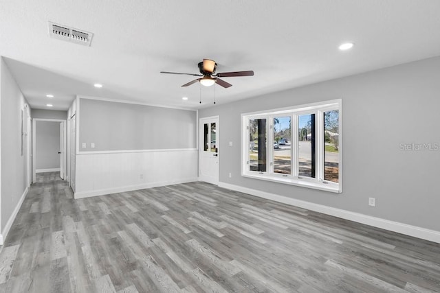 unfurnished living room with recessed lighting, visible vents, ceiling fan, and wood finished floors