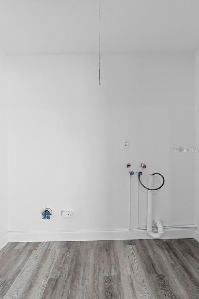 laundry room featuring laundry area, washer hookup, wood finished floors, and baseboards