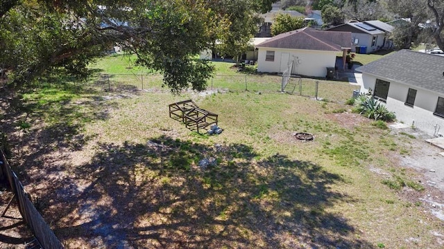 view of yard with a fire pit and fence