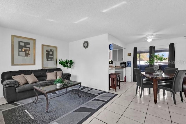 living room featuring a textured ceiling and ceiling fan