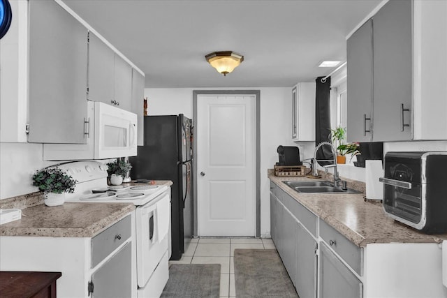 kitchen with a sink, white appliances, light tile patterned flooring, a toaster, and light countertops