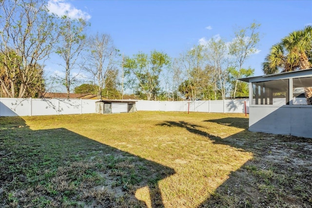 view of yard featuring a fenced backyard and a sunroom