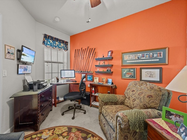 carpeted office space featuring a ceiling fan