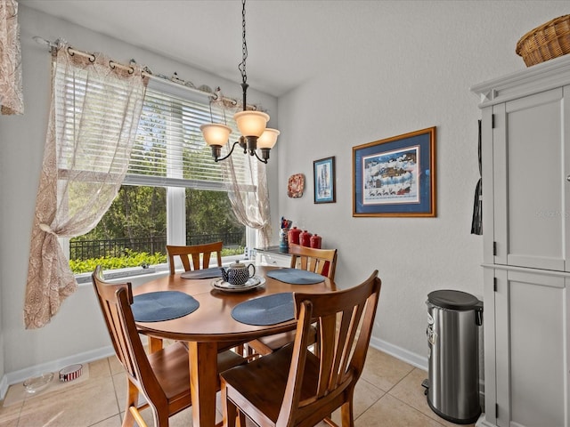 dining room featuring a chandelier, baseboards, and light tile patterned floors