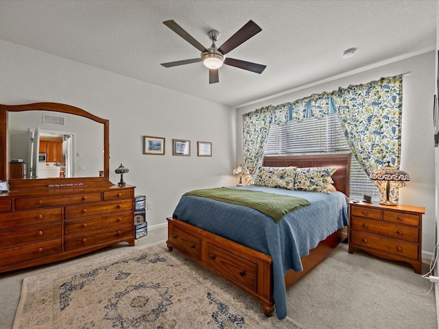 carpeted bedroom with baseboards, visible vents, and a ceiling fan