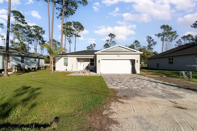 ranch-style home with decorative driveway, an attached garage, stucco siding, and a front yard