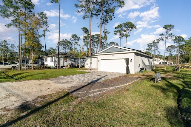 view of front of home with a garage, decorative driveway, a front lawn, and stucco siding