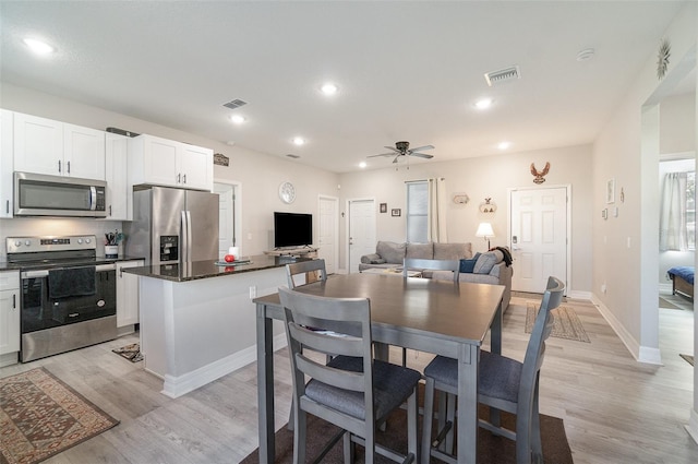 dining space with baseboards, recessed lighting, visible vents, and light wood-style floors