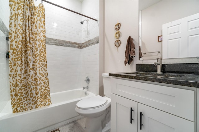 bathroom featuring shower / bath combination with curtain, vanity, toilet, and wood finished floors