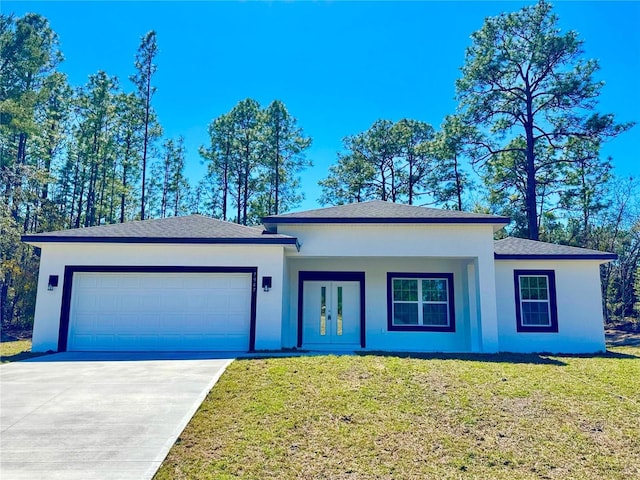 view of front of house featuring a front yard, an attached garage, french doors, and stucco siding