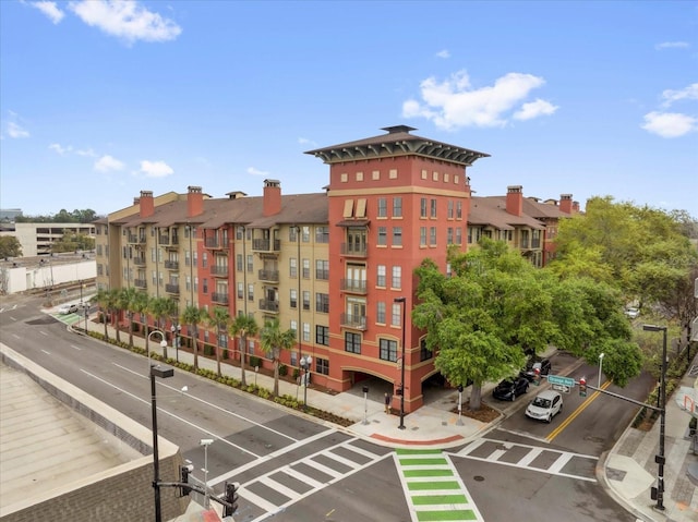 view of building exterior featuring uncovered parking