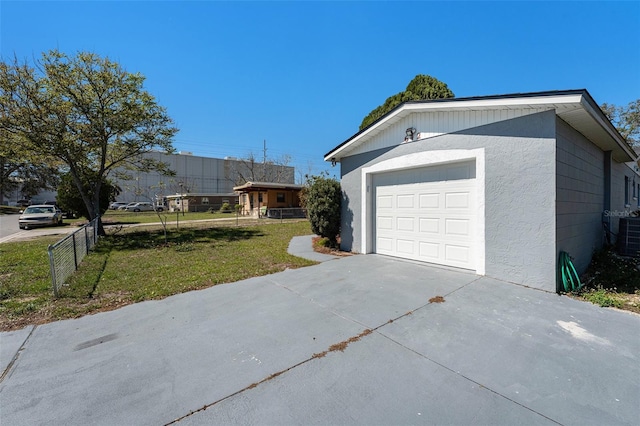 exterior space featuring central AC, concrete driveway, and fence