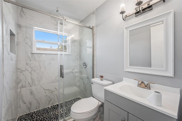 bathroom with a marble finish shower, toilet, and vanity