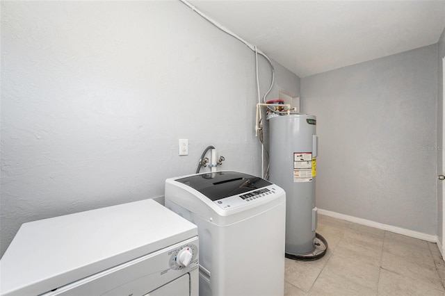 laundry room featuring washer and dryer, laundry area, baseboards, and water heater