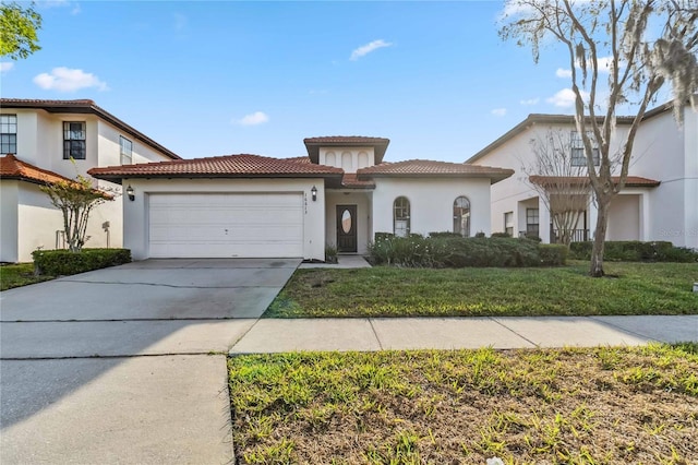 mediterranean / spanish-style home featuring a front lawn, a tile roof, stucco siding, a garage, and driveway