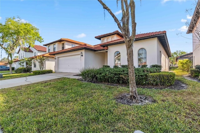 view of front of house with a front yard, driveway, an attached garage, stucco siding, and a tiled roof