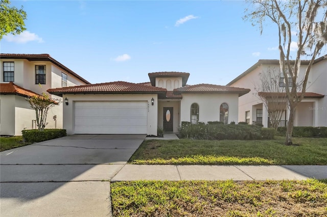 mediterranean / spanish house featuring stucco siding, driveway, a front lawn, and a garage