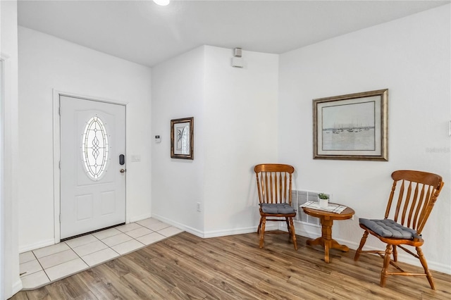 entryway featuring wood finished floors and baseboards