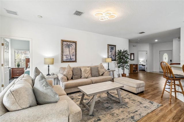 living area featuring wood finished floors and visible vents