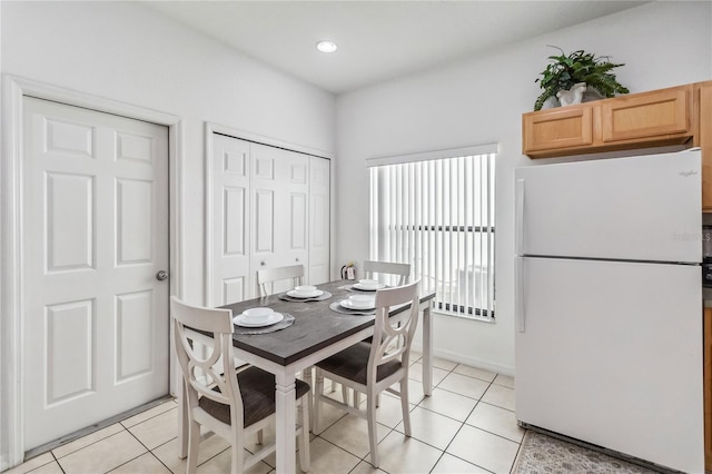 dining space featuring light tile patterned flooring and recessed lighting