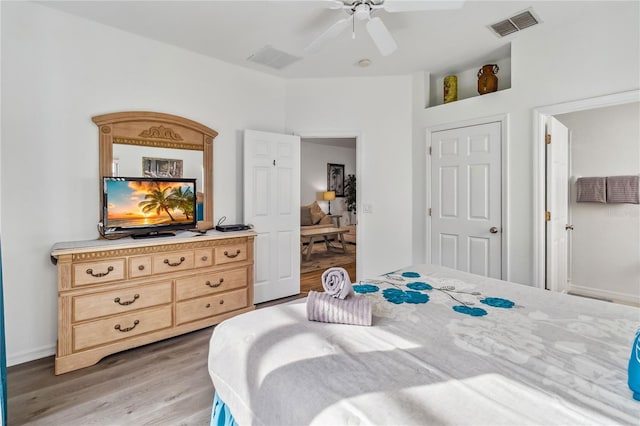 bedroom featuring visible vents, light wood-style flooring, and ceiling fan