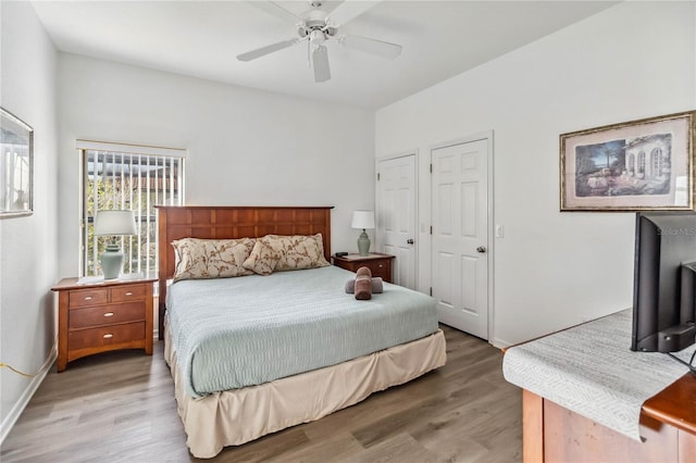 bedroom with a ceiling fan, light wood-style floors, and baseboards