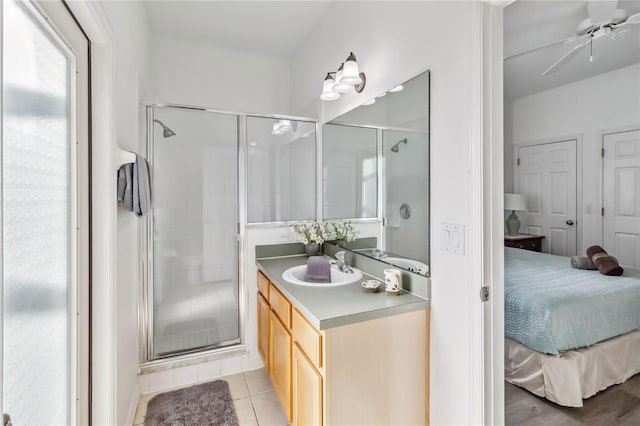 bathroom featuring a stall shower, connected bathroom, tile patterned flooring, ceiling fan, and vanity