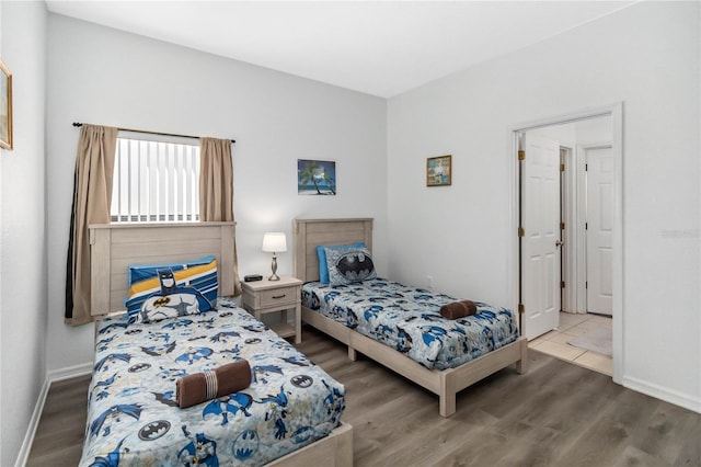 bedroom featuring baseboards and wood finished floors