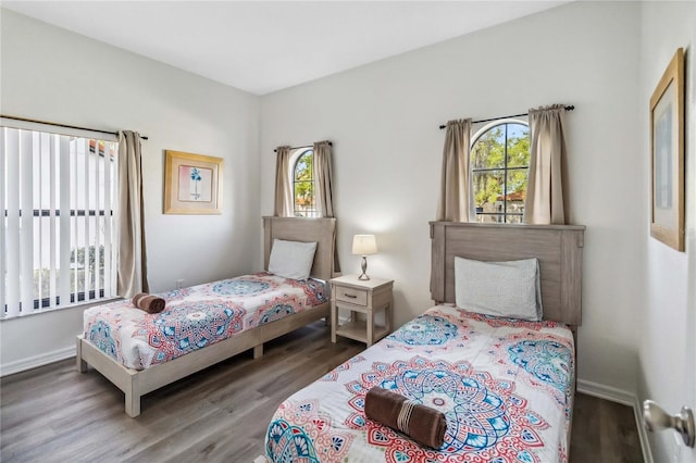 bedroom with wood finished floors and baseboards