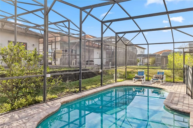 pool featuring a residential view, glass enclosure, and a patio