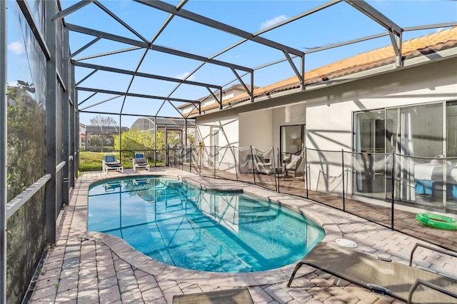 outdoor pool with a patio area and glass enclosure