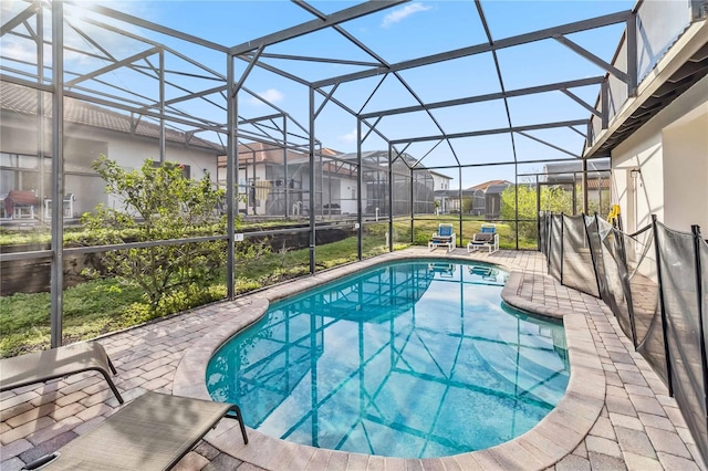 outdoor pool featuring a lanai, a residential view, and a patio