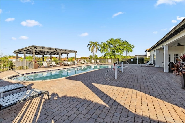 pool with ceiling fan, a pergola, a patio, and fence