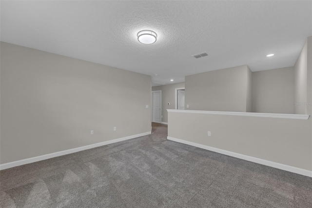 carpeted spare room with recessed lighting, visible vents, baseboards, and a textured ceiling